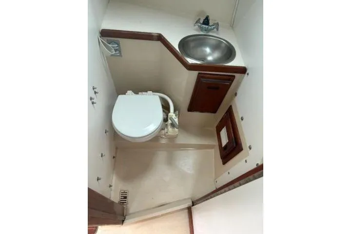 Slide: The Image of Compact bathroom in 1989 Catalina 30 sailboat with toilet and sink. - 10