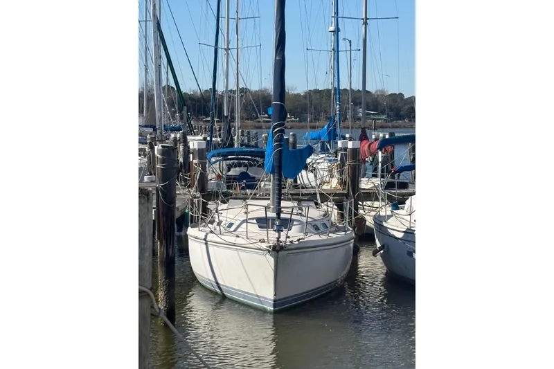 Slide: The Image of 1989 Catalina TRBSWK sailboat docked at marina, surrounded by other boats. - 2