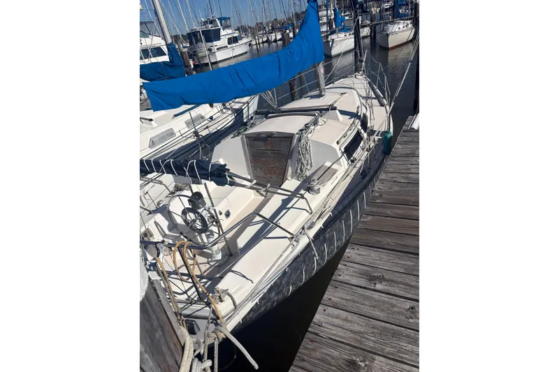 Slide: The Image of 1989 Catalina TRBSWK sailboat docked at marina with blue sail cover. - 3