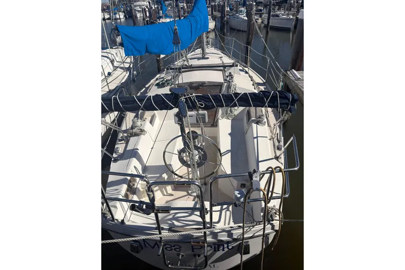 Slide: The Image of 1989 Catalina TRBSWK sailboat docked, featuring a spacious cockpit and blue sail cover. - 4
