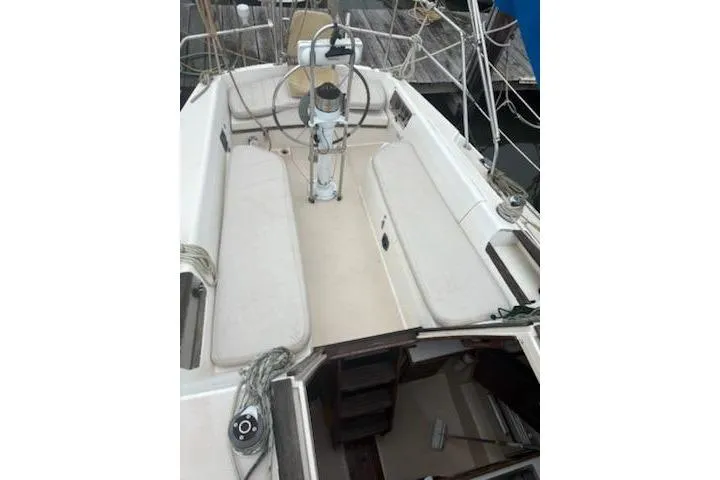 Slide: The Image of 1989 Catalina 30 sailboat cockpit with dual benches and steering wheel. - 5