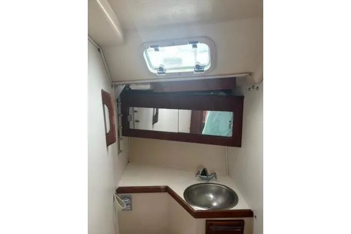 Slide: The Image of Interior of 1989 Catalina 30 sailboat bathroom with sink and mirror. - 9