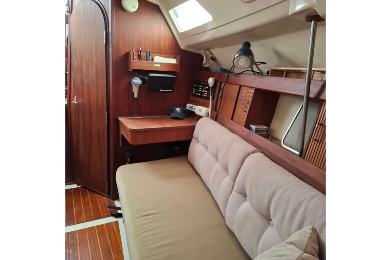Slide: The Image of Interior of 1989 Hunter 30 sailboat with wooden paneling and cozy seating area. - 11