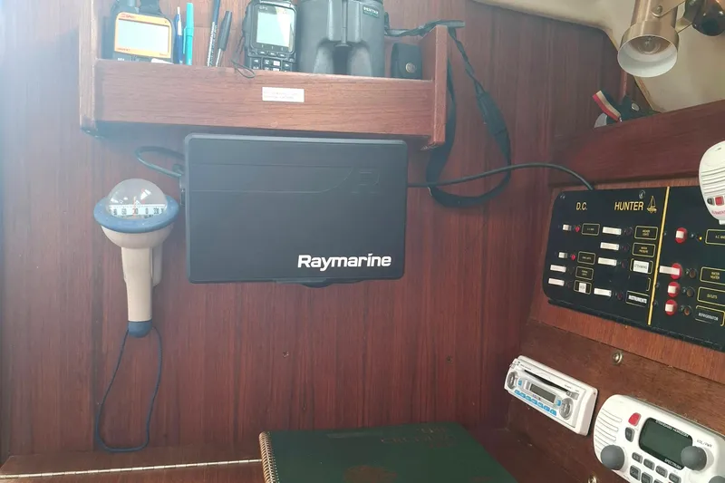 Slide: The Image of Control panel and navigation equipment inside a 1989 Hunter 30 sailboat cabin. - 12