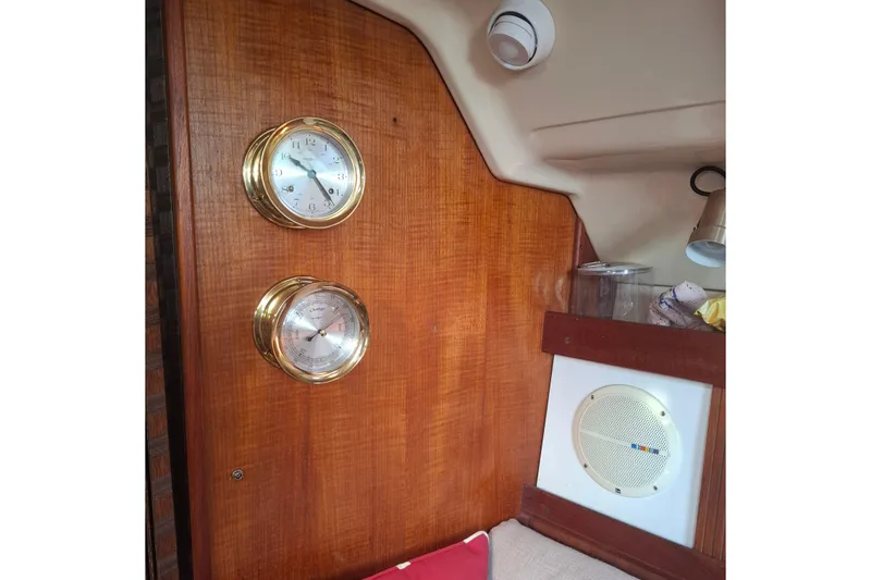 Slide: The Image of Interior of 1989 Hunter 30 sailboat with brass clock and barometer on wooden panel. - 17