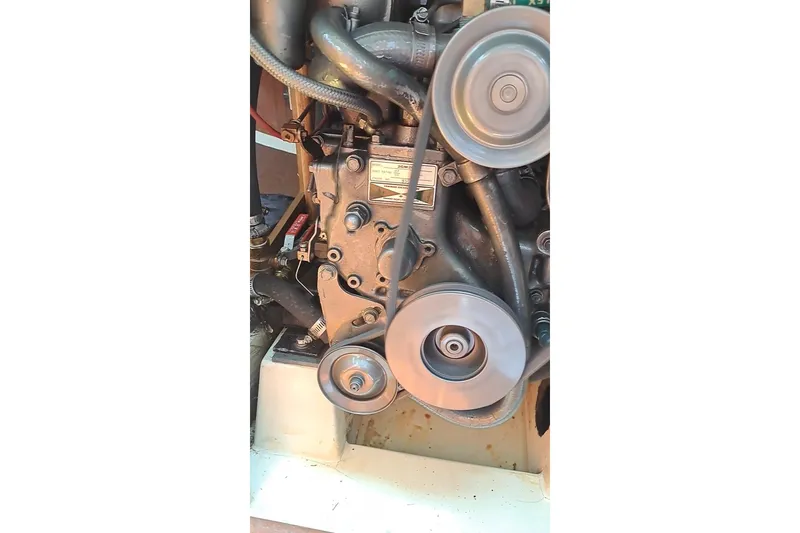 Slide: The Image of Engine of a 1989 Hunter 30 sailboat with visible pulleys and belts. - 24