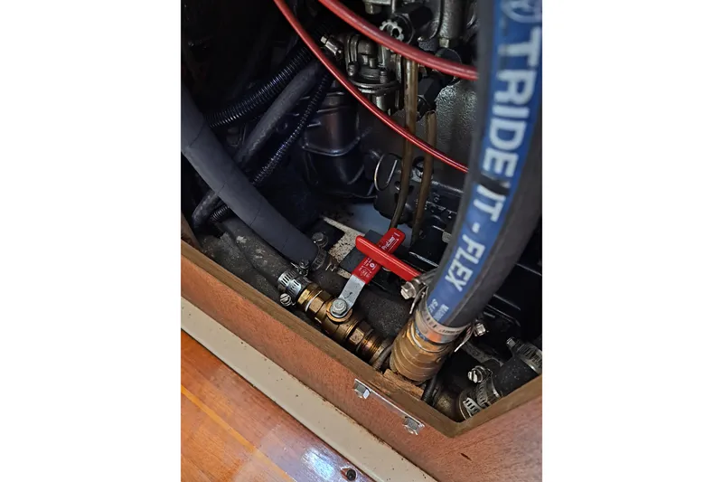 Slide: The Image of Engine compartment of a 1989 Hunter 30 sailboat, showing hoses and valves. - 25
