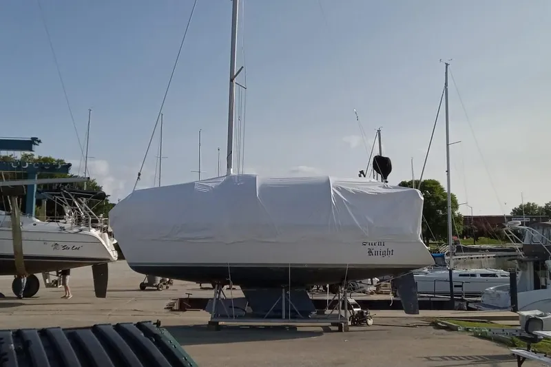 Slide: The Image of 1989 Hunter 30 sailboat covered in white tarp at marina. - 27