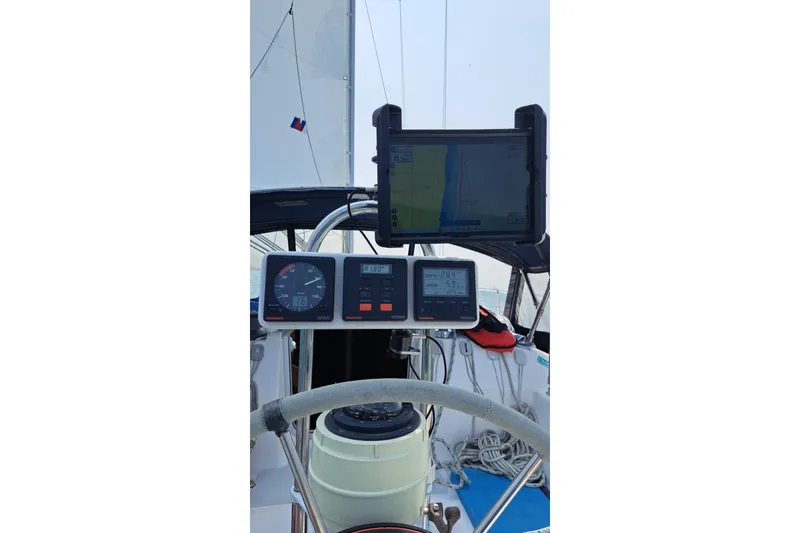 Slide: The Image of Cockpit of 1989 Hunter 30 sailboat with navigation instruments and steering wheel. - 5