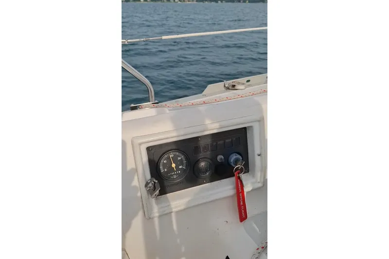 Slide: The Image of Control panel of a 1989 Hunter 30 sailboat with key and gauge, overlooking water. - 6