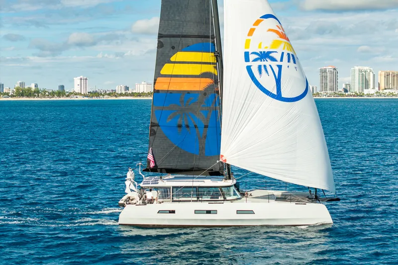 The Image of Luxury Harvey Yachts 58 sailing near city skyline, 2017 model, vibrant sails, blue ocean backdrop. - 0
