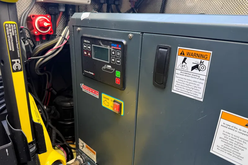 Slide: The Image of Control panel of a 2017 Harvey Yachts 58, featuring warning labels and wiring. - 101