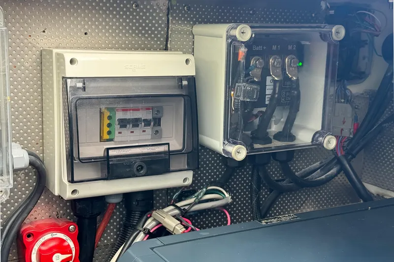 Slide: The Image of Electrical panel and wiring inside a 2017 Harvey Yachts 58, showcasing circuit breakers and connections. - 102