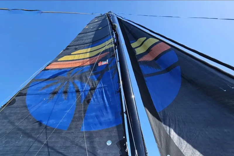 Slide: The Image of Sail of a 2017 Harvey Yachts 58 with colorful design against blue sky. - 105