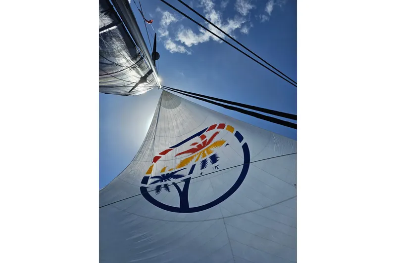 Slide: The Image of Sail of 2017 Harvey Yachts 58 against blue sky, featuring colorful logo design. - 106