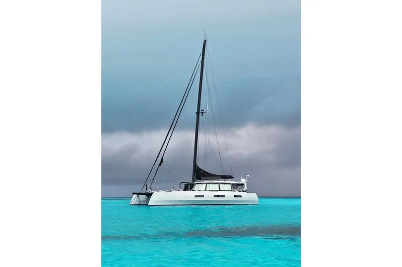 Slide: The Image of Sleek 2017 Harvey Yachts 58 catamaran on turquoise waters under cloudy skies. - 118