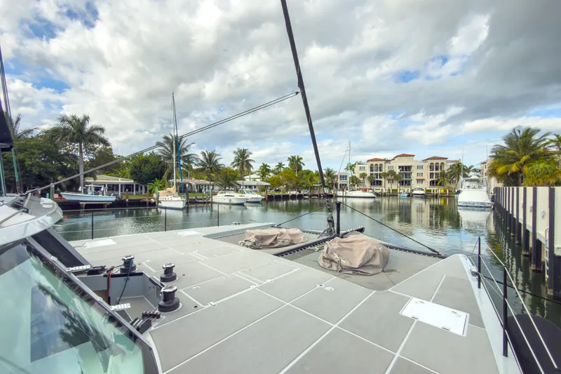 Slide: The Image of Harvey Yachts 58 (2017) docked in a scenic marina with palm trees and waterfront homes. - 16