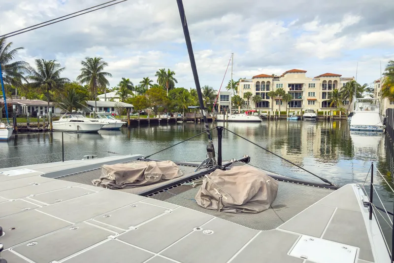 Slide: The Image of Harvey Yachts 58 (2017) docked in a scenic marina with palm trees and luxury buildings. - 17