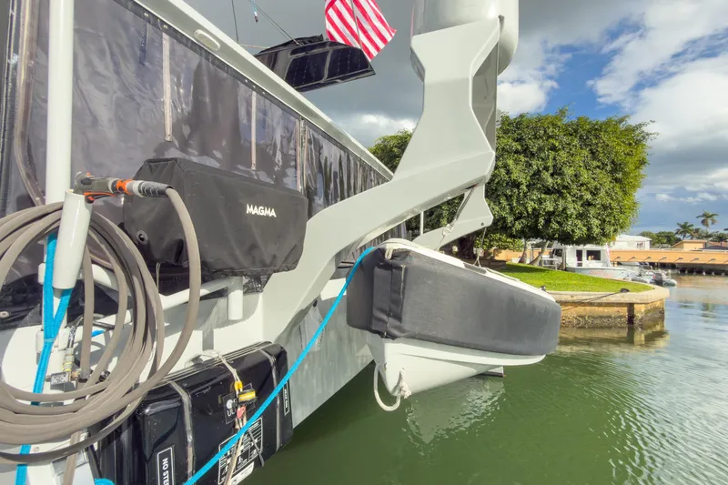 Slide: The Image of 2017 Harvey Yachts 58 docked, featuring equipment and American flag, with scenic waterfront view. - 19
