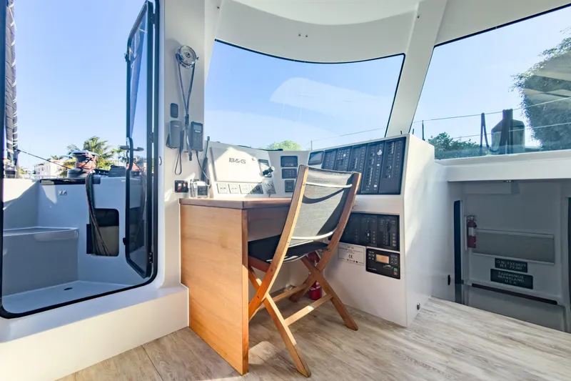 Slide: The Image of Modern helm station of 2017 Harvey Yachts 58 with navigation equipment and wooden chair. - 48