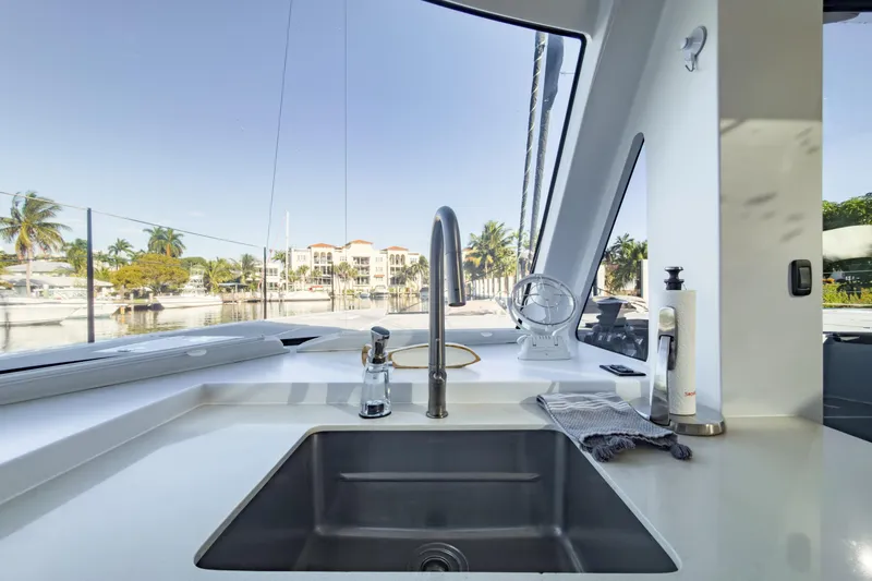 Slide: The Image of Modern kitchen sink on 2017 Harvey Yachts 58, with marina view through large windows. - 51