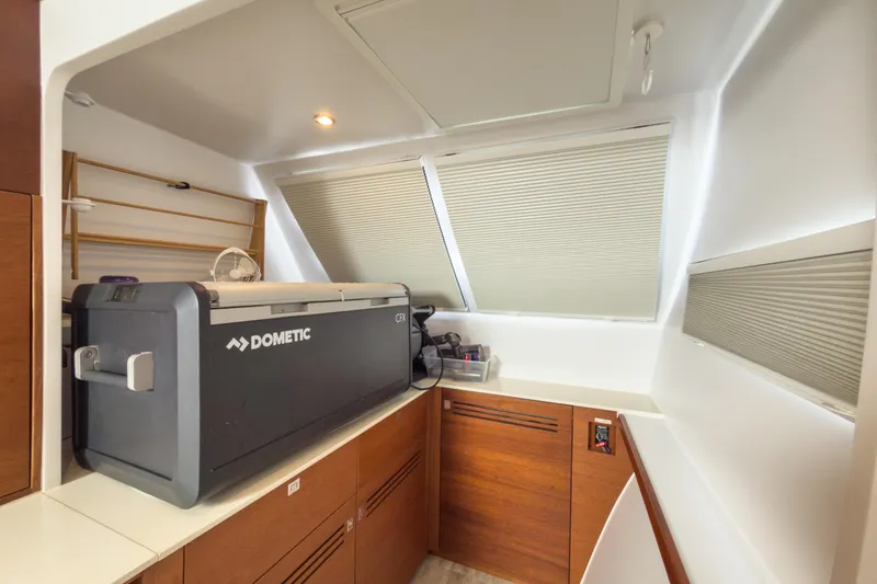 Slide: The Image of Interior of 2017 Harvey Yachts 58 featuring a Dometic CFX cooler and wooden cabinetry. - 58