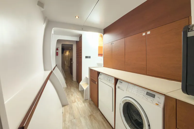Slide: The Image of Laundry area on 2017 Harvey Yachts 58, featuring modern appliances and wood cabinetry. - 59