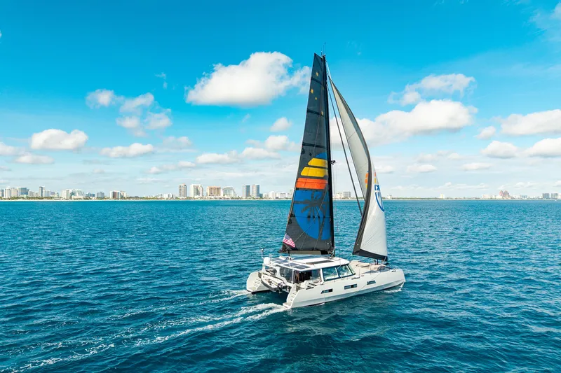 Slide: The Image of Sailing yacht Harvey Yachts 58, 2017 model, cruising on blue ocean near city skyline. - 6