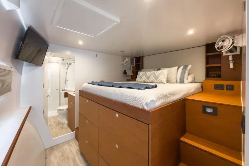 Slide: The Image of Luxurious cabin interior of 2017 Harvey Yachts 58 with bed, TV, and ensuite bathroom. - 60