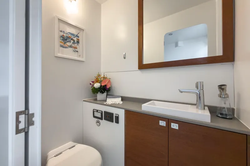 Slide: The Image of Modern bathroom on 2017 Harvey Yachts 58, featuring sleek sink, mirror, and floral decor. - 69