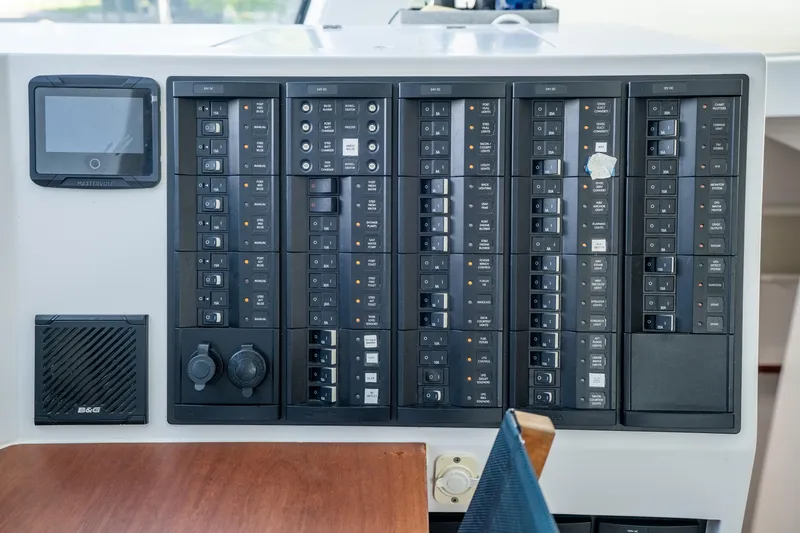 Slide: The Image of Control panel of a 2017 Harvey Yachts 58, featuring various switches and displays. - 72