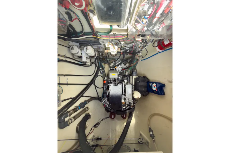 Slide: The Image of Engine room of a 2017 Harvey Yachts 58, showcasing complex wiring and machinery. - 77