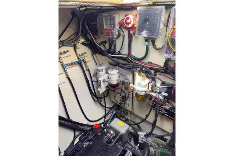 Slide: The Image of Engine room of a 2017 Harvey Yachts 58, showcasing wiring and fuel filters. - 82