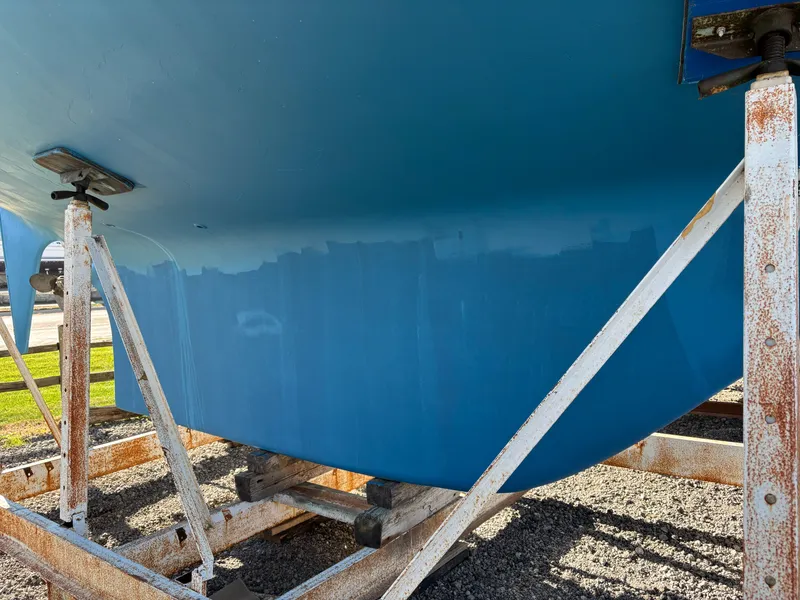 Slide: The Image of Blue hull of a 1979 Hallberg-Rassy 38 sailboat on a metal stand. - 16