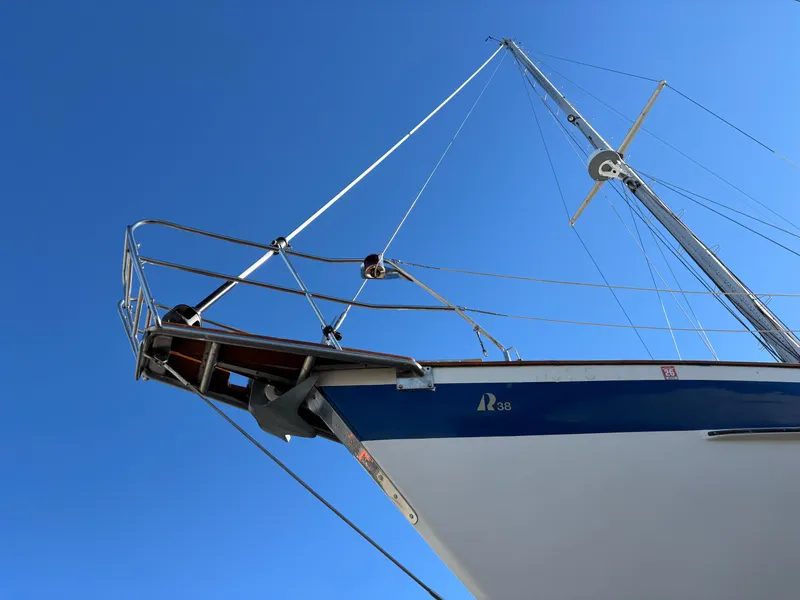 Slide: The Image of 1979 Hallberg-Rassy 38 sailboat bow against clear blue sky. - 19