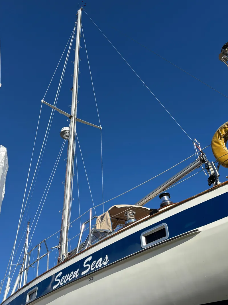 Slide: The Image of 1979 Hallberg-Rassy 38 sailboat "Seven Seas" against a clear blue sky. - 21