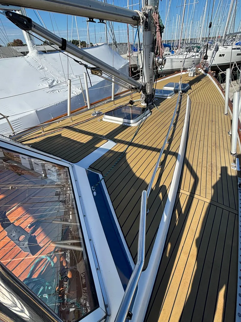 Slide: The Image of 1979 Hallberg-Rassy 38 sailboat deck with wooden finish and rigging details. - 26