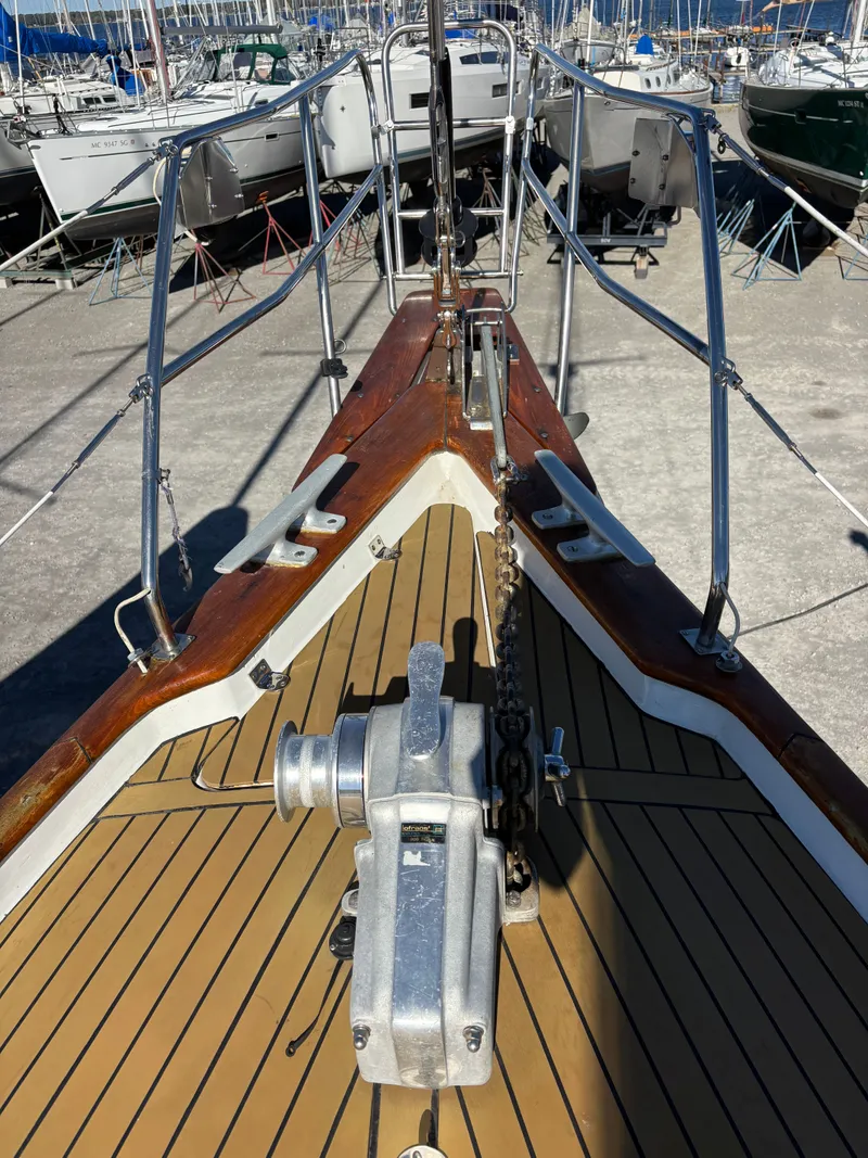 Slide: The Image of 1979 Hallberg-Rassy 38 sailboat deck with anchor winch and wooden trim. - 31