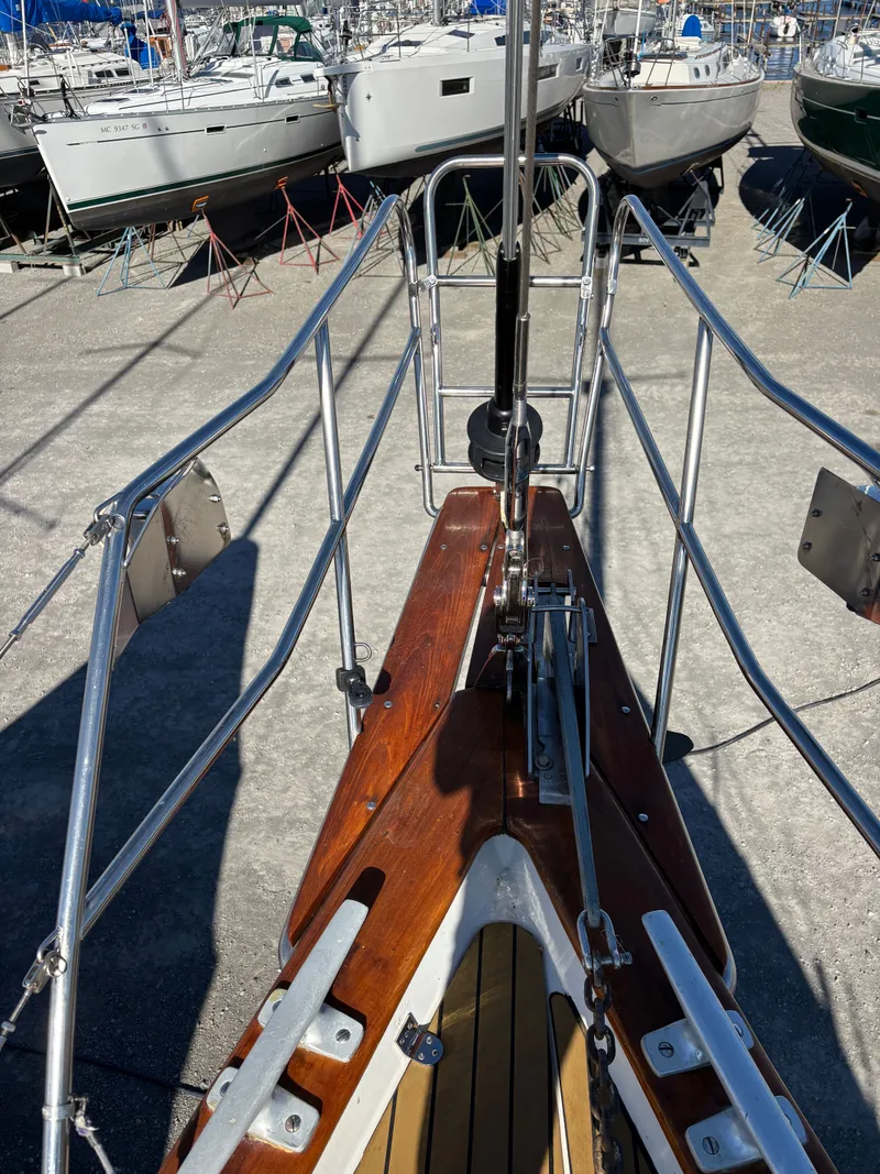 Slide: The Image of Bow of a 1979 Hallberg-Rassy 38 sailboat with polished wood and metal fittings. - 34