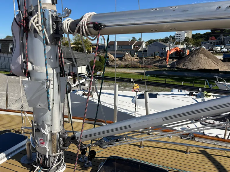 Slide: The Image of 1979 Hallberg-Rassy 38 sailboat mast and rigging in a marina setting. - 39