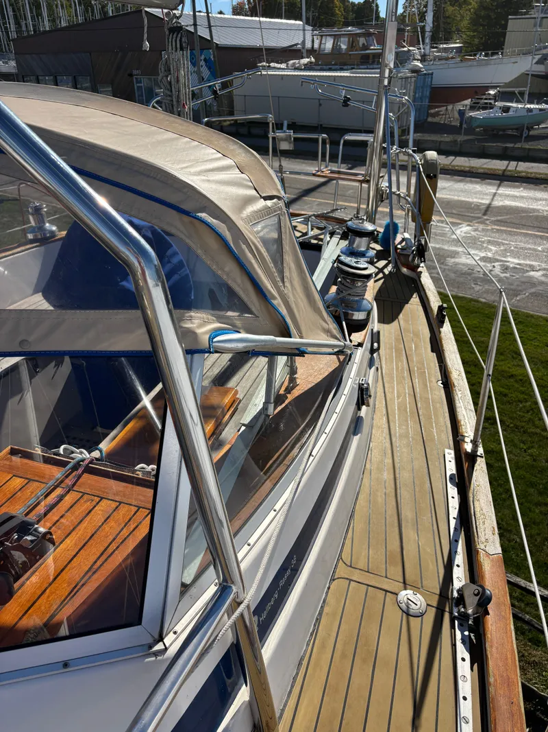 Slide: The Image of 1979 Hallberg-Rassy 38 sailboat deck with wooden details and protective canopy. - 41