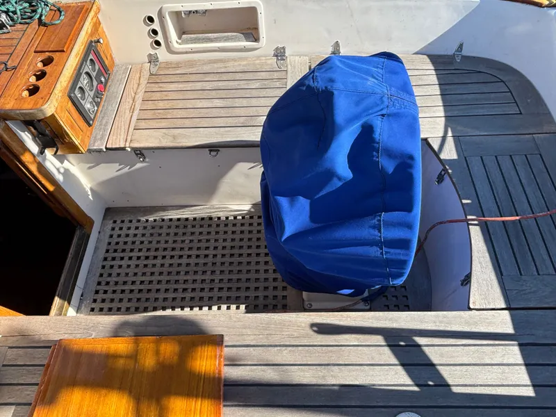 Slide: The Image of Cockpit of 1979 Hallberg-Rassy 38 sailboat with blue cover and wooden details. - 43