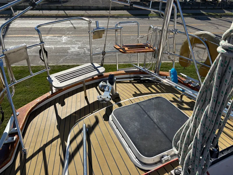 Slide: The Image of 1979 Hallberg-Rassy 38 sailboat deck with teak flooring and stainless steel railings. - 45