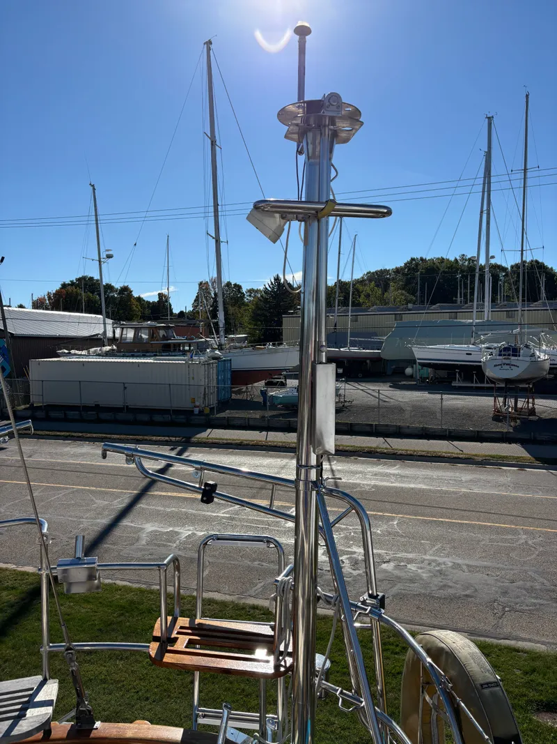 Slide: The Image of 1979 Hallberg-Rassy 38 sailboat with stainless steel fittings, docked in a sunny marina. - 47