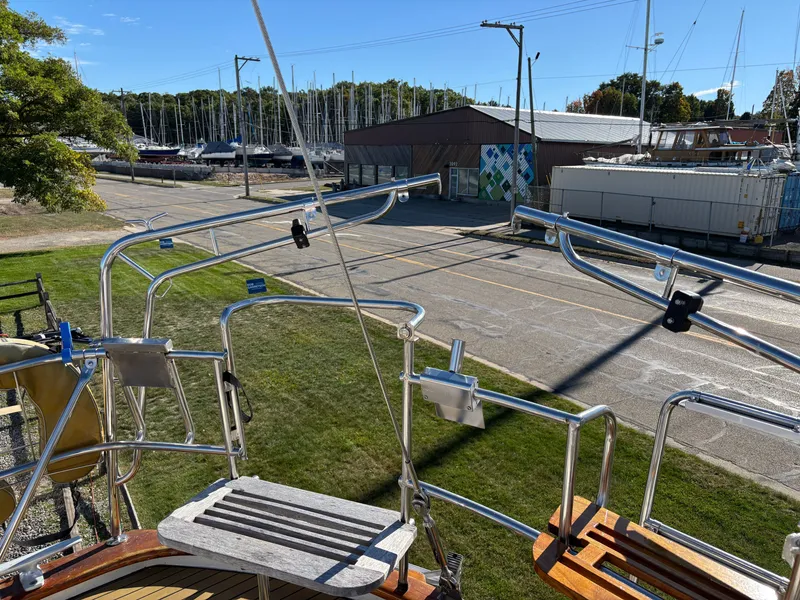 Slide: The Image of 1979 Hallberg-Rassy 38 sailboat deck with marina view and clear blue sky. - 48