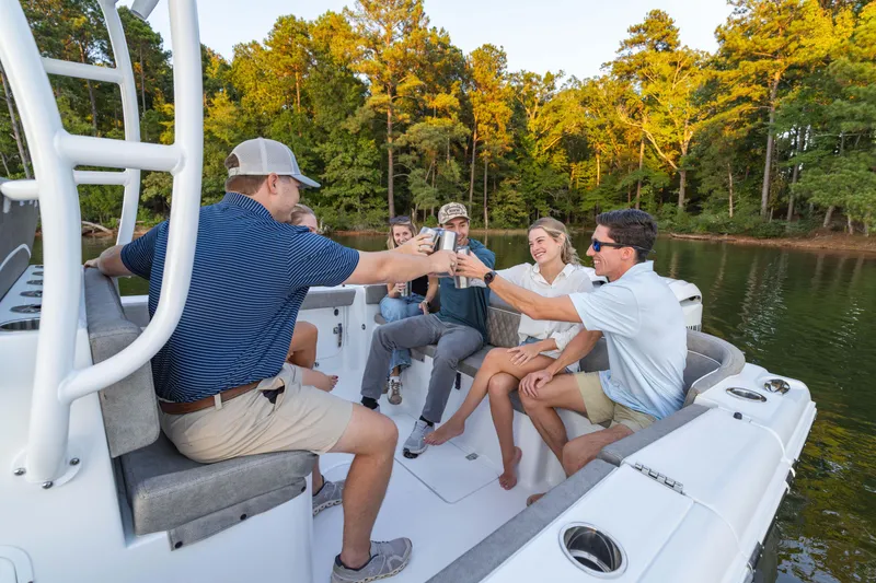 Slide: The Image of Group enjoying on a 2026 Sea Hunt Ultra 305 Coffin Box boat, surrounded by nature. - 10