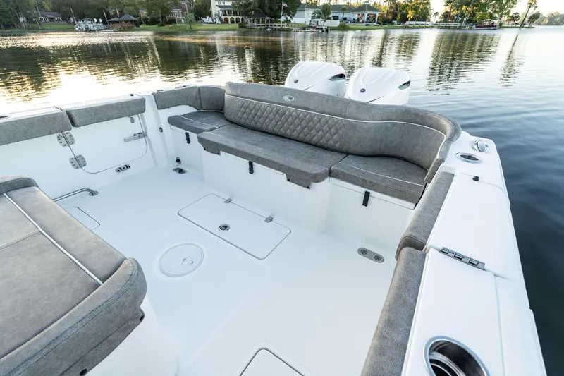 Slide: The Image of 2026 Sea Hunt Ultra 305 Coffin Box boat interior with cushioned seating and water view. - 16