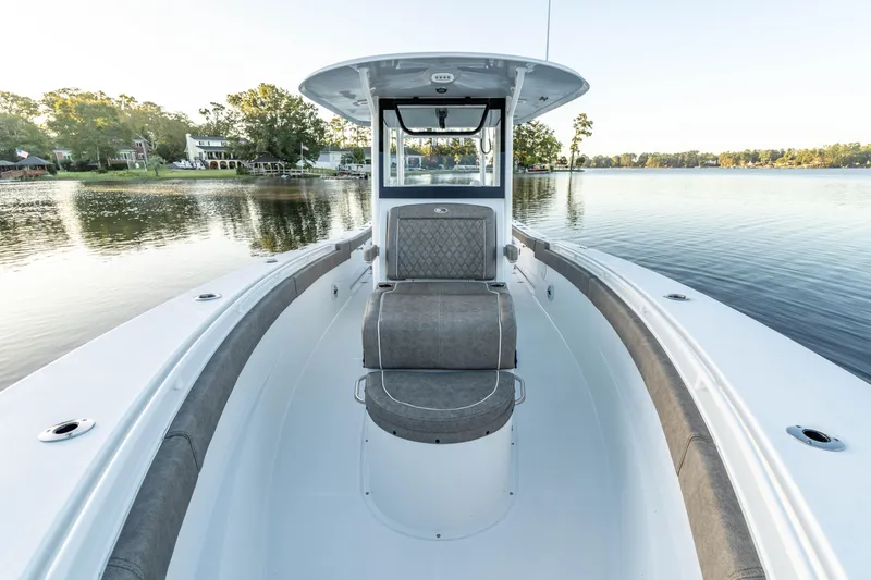 Slide: The Image of 2026 Sea Hunt Ultra 305 Coffin Box boat on calm lake, featuring spacious seating. - 18