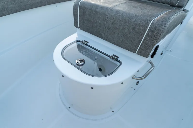 Slide: The Image of 2026 Sea Hunt Ultra 305 Coffin Box interior with cushioned seating and storage compartment. - 20