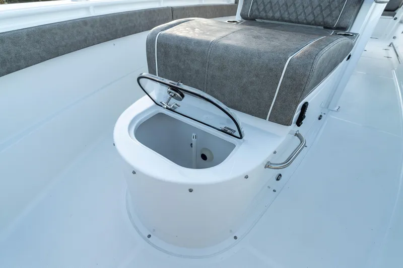 Slide: The Image of 2026 Sea Hunt Ultra 305 Coffin Box with open storage compartment on deck. - 21